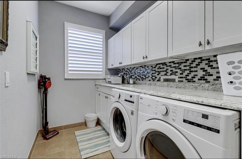 3402 Tigris Lane Naples, FL 34119 - Photo 36 of 50 a utility room with dryer and washer