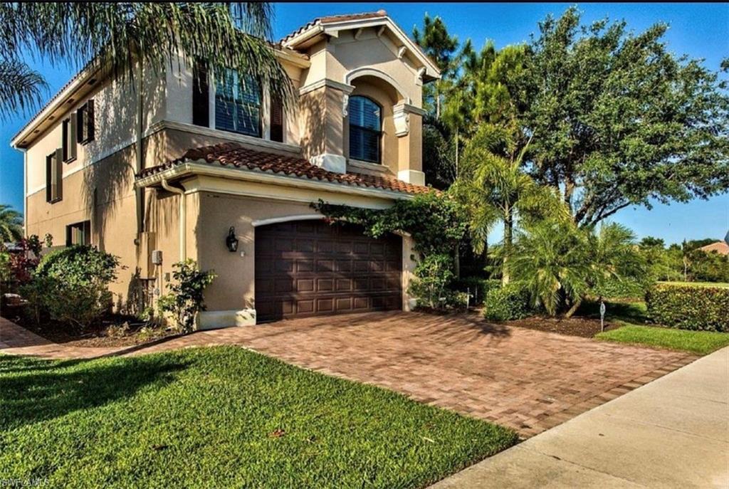 3402 Tigris Lane Naples, FL 34119 - Photo 37 of 50 a view of a house with a small yard and a large tree