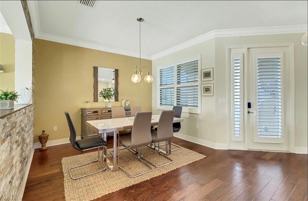 3402 Tigris Lane Naples, FL 34119 - Photo 6 of 50 a view of a dining room with furniture window and wooden floor