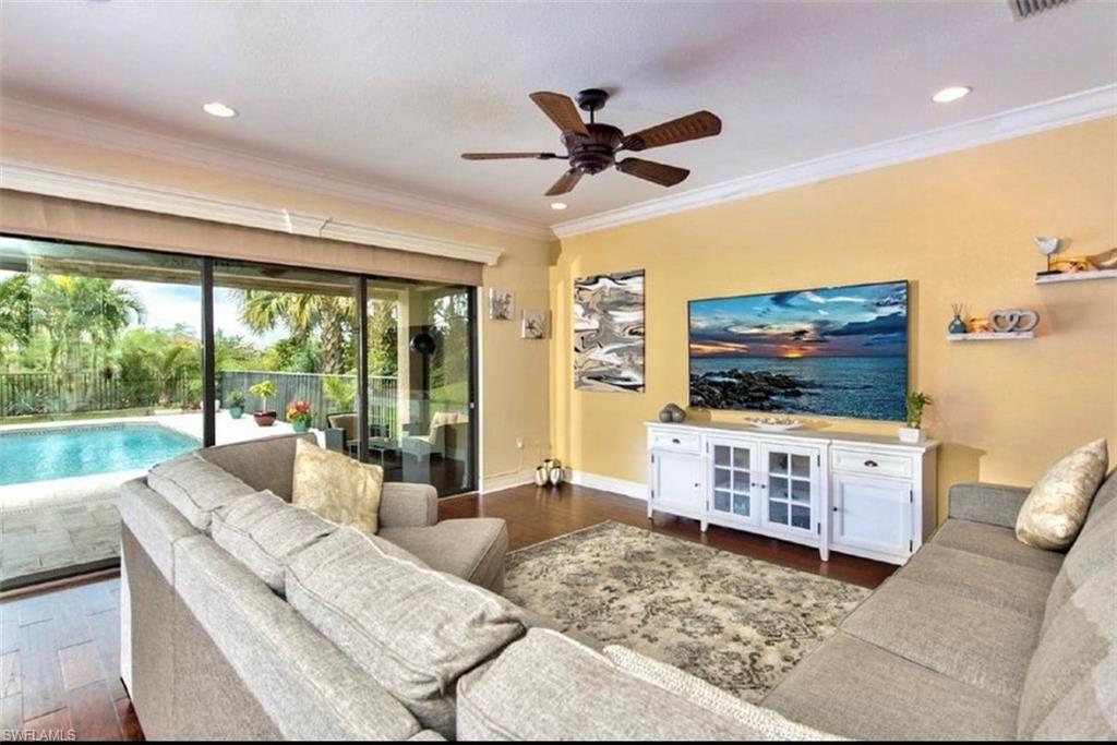 3402 Tigris Lane Naples, FL 34119 - Photo 7 of 50 a living room with furniture and a flat screen tv