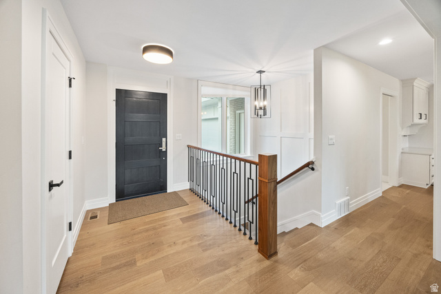 1774 Country Club Drive Logan, UT 84321 - Photo 20 of 28 Entryway featuring wood-finish flooring, a dark paneled door, and a modern ceiling light