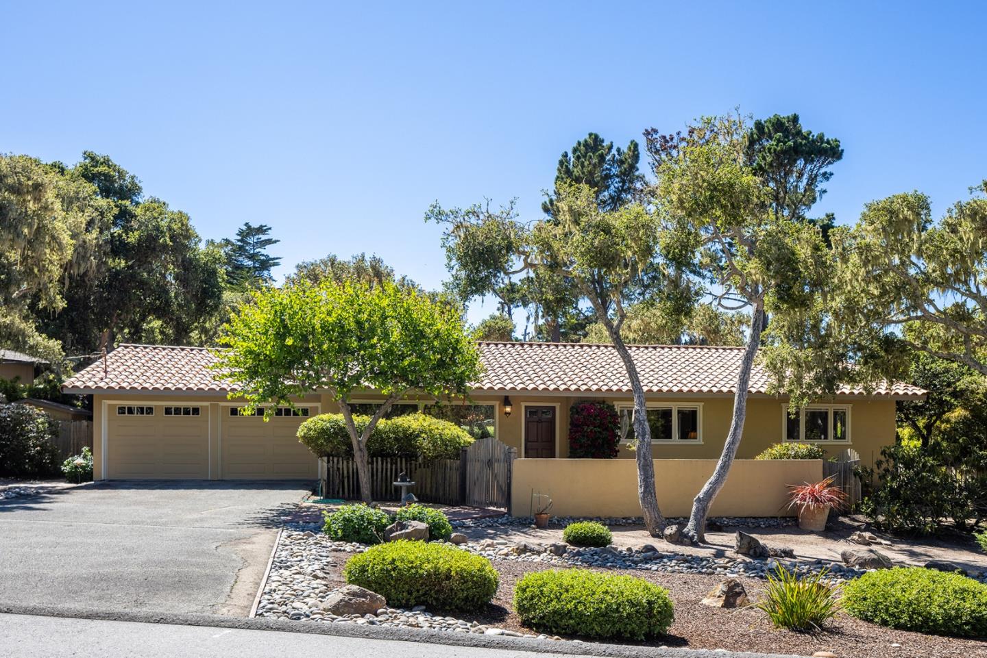 2984 Crescent Drive Pebble Beach, CA 93953 - Photo 1 of 22 a front view of a house with a yard and garage
