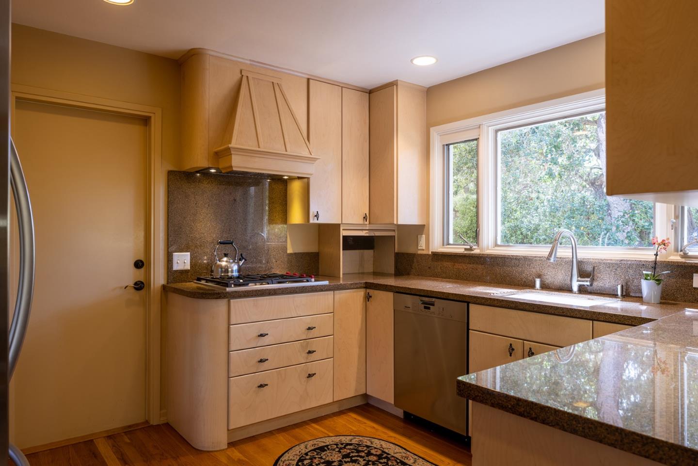 2984 Crescent Drive Pebble Beach, CA 93953 - Photo 8 of 22 a kitchen with a sink a stove and a refrigerator