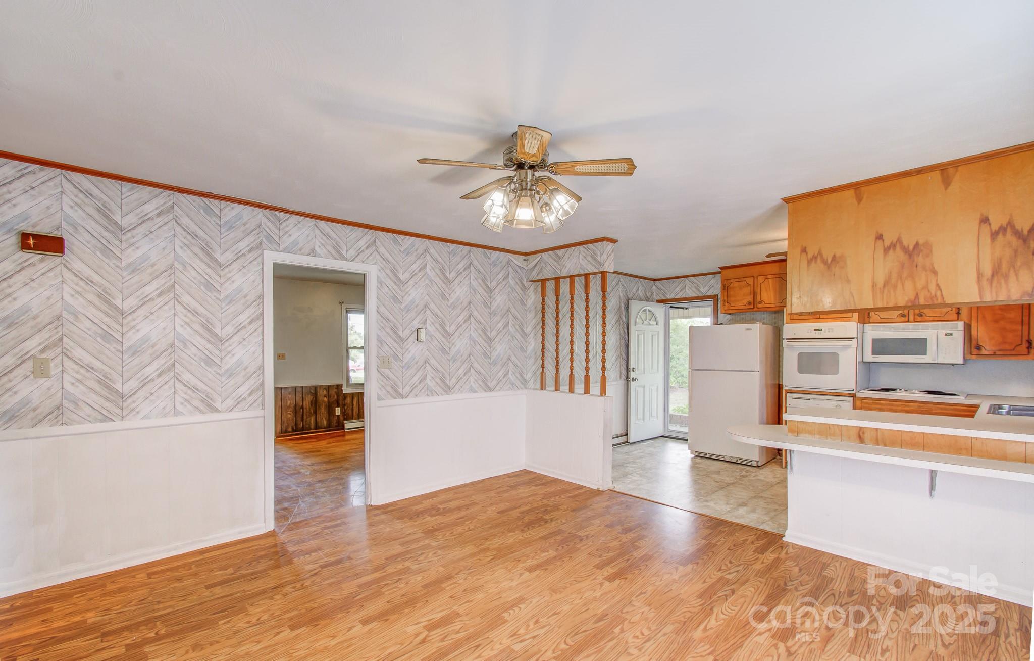 617 Oak Grove Road Kings Mountain, NC 28086 - Photo 11 of 32 a view of a kitchen with a stove cabinets and a floor to ceiling window