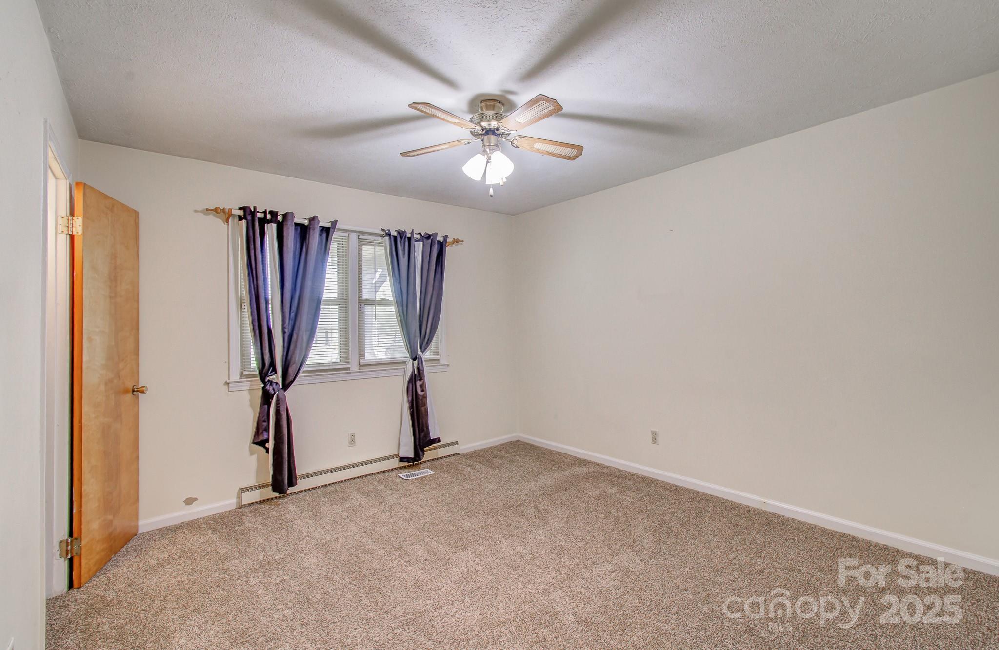 617 Oak Grove Road Kings Mountain, NC 28086 - Photo 13 of 32 an empty room with windows and fan