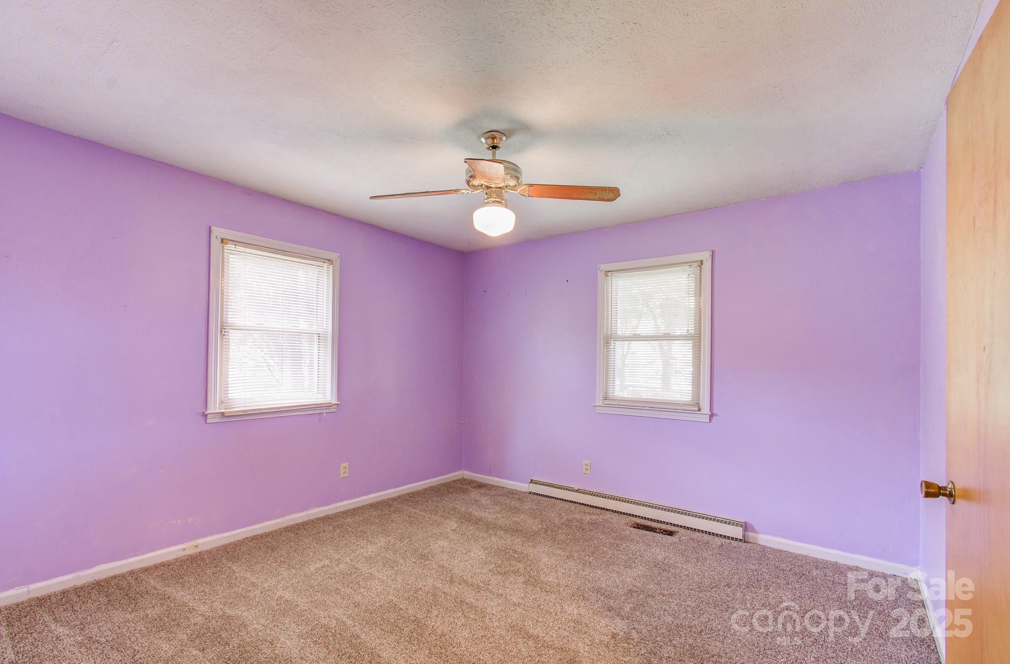 617 Oak Grove Road Kings Mountain, NC 28086 - Photo 17 of 32 an empty room with windows and ceiling fan