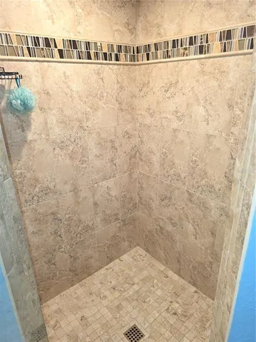 a bedroom with a bed wooden floor and window