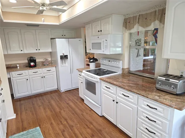 a kitchen with stainless steel appliances a stove a sink and a refrigerator