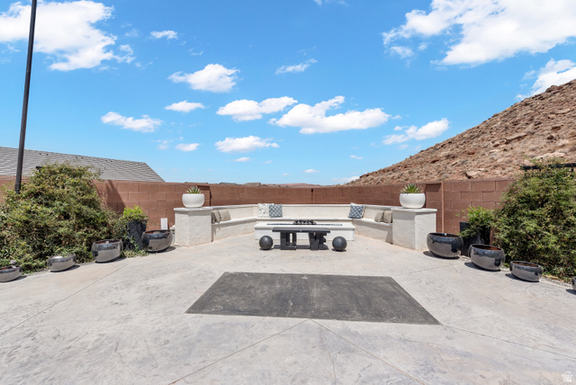 6105 Bunda Way St. George, UT 84790 - Photo 40 of 49 Expansive hardscaped patio featuring a built-in bench seating area