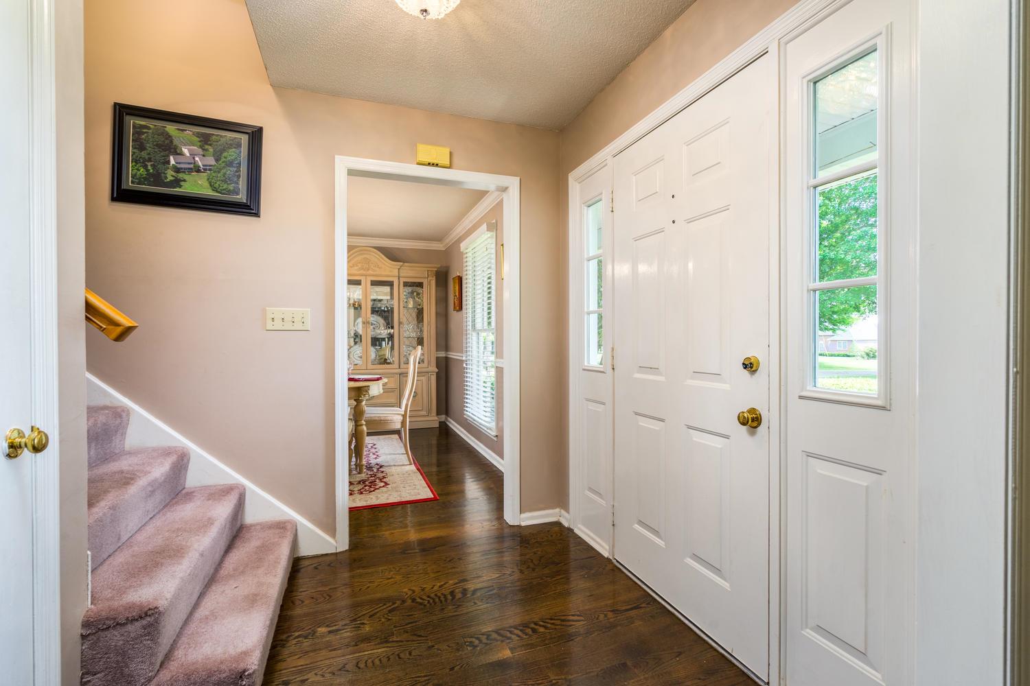 4650 Sango Road Clarksville, TN 37043 - Photo 11 of 30 a view of a hallway with wooden floor and a living room