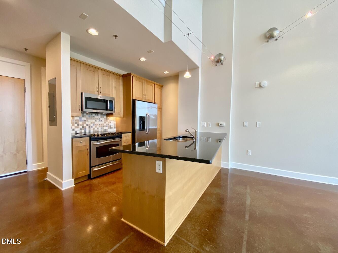 2608 Erwin Road, Unit 428 Durham, NC 27705 - Photo 5 of 33 a large kitchen with a large counter top stainless steel appliances and cabinets