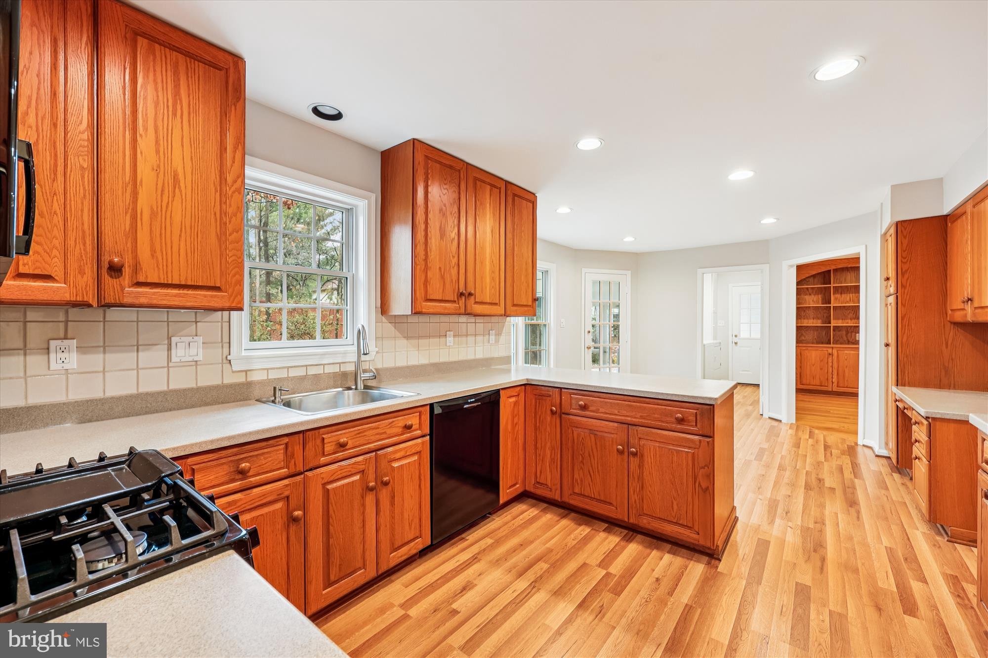 8212 Killean Way Potomac, MD 20854 - Photo 12 of 51 a kitchen with stainless steel appliances granite countertop a sink a stove and wooden cabinets