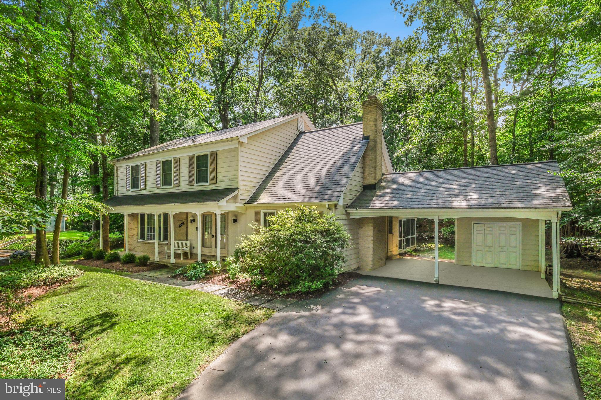 8212 Killean Way Potomac, MD 20854 - Photo 2 of 51 a front view of a house with a garden