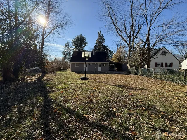 a view of large yard with a fountain and large trees
