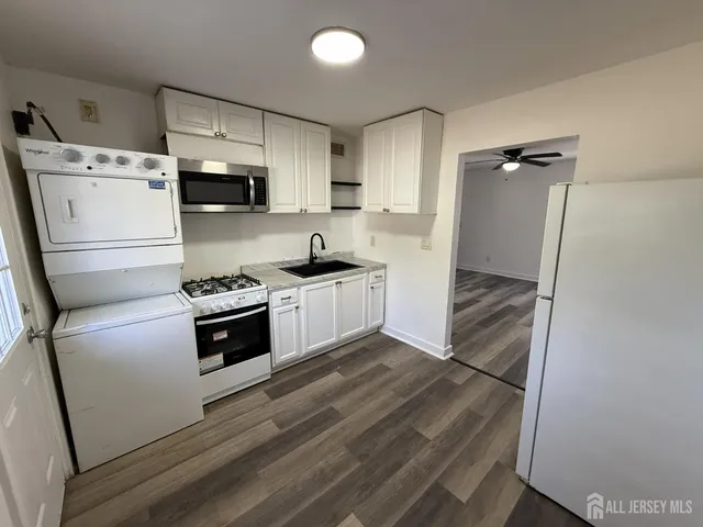 a kitchen with a refrigerator a stove top oven a sink and dishwasher