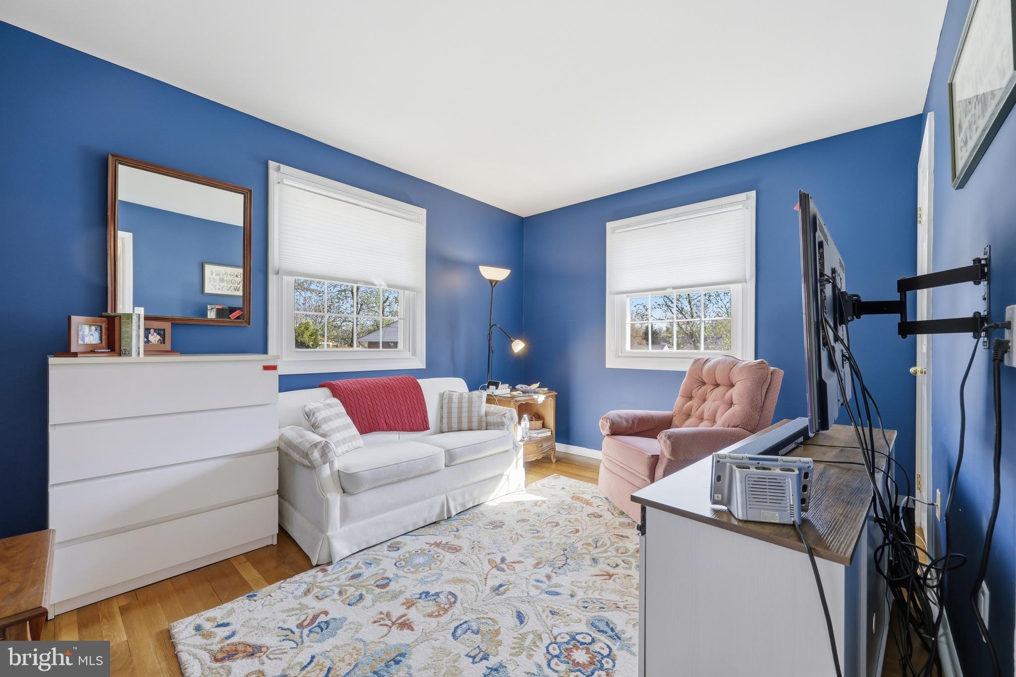 12709 Castleleigh Court Silver Spring, MD 20904 - Photo 21 of 38 a living room with furniture a flat screen tv and a window