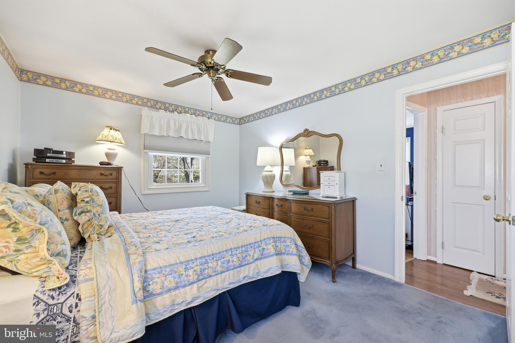 12709 Castleleigh Court Silver Spring, MD 20904 - Photo 25 of 38 a bedroom with a large bed a chandelier and dresser