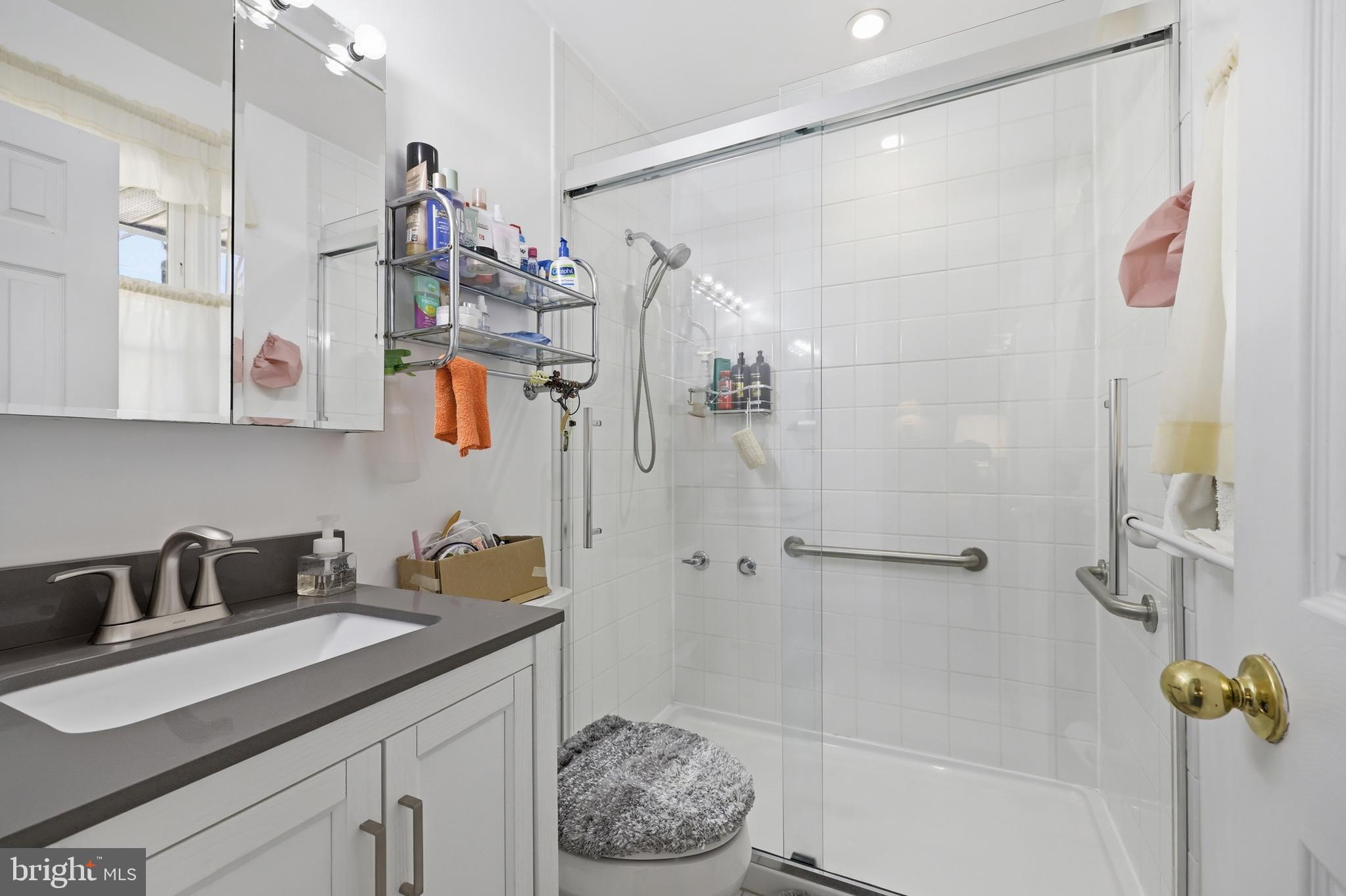 12709 Castleleigh Court Silver Spring, MD 20904 - Photo 26 of 38 a bathroom with a granite countertop sink a toilet and shower