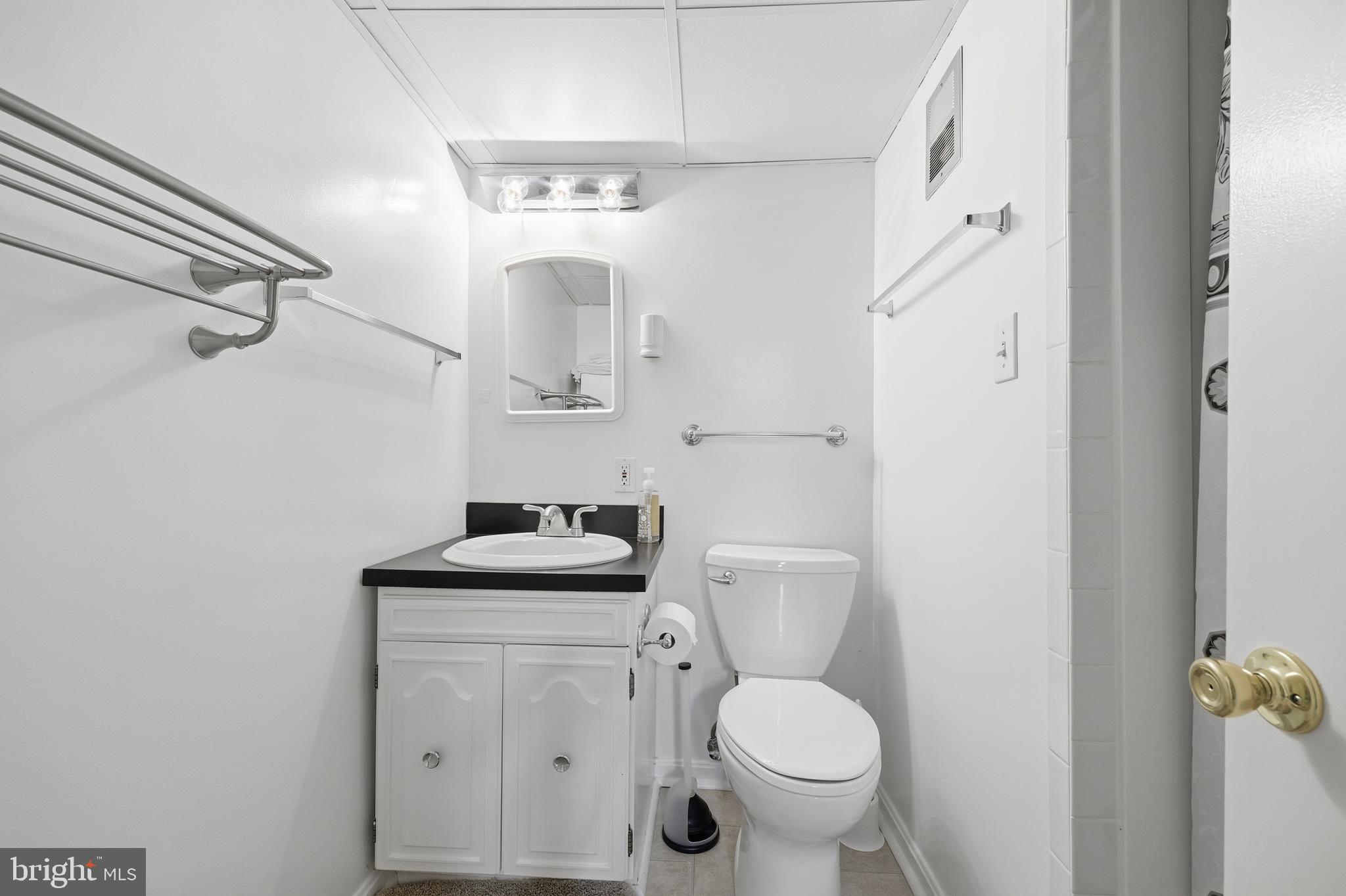 12709 Castleleigh Court Silver Spring, MD 20904 - Photo 29 of 38 a bathroom with a toilet sink and mirror