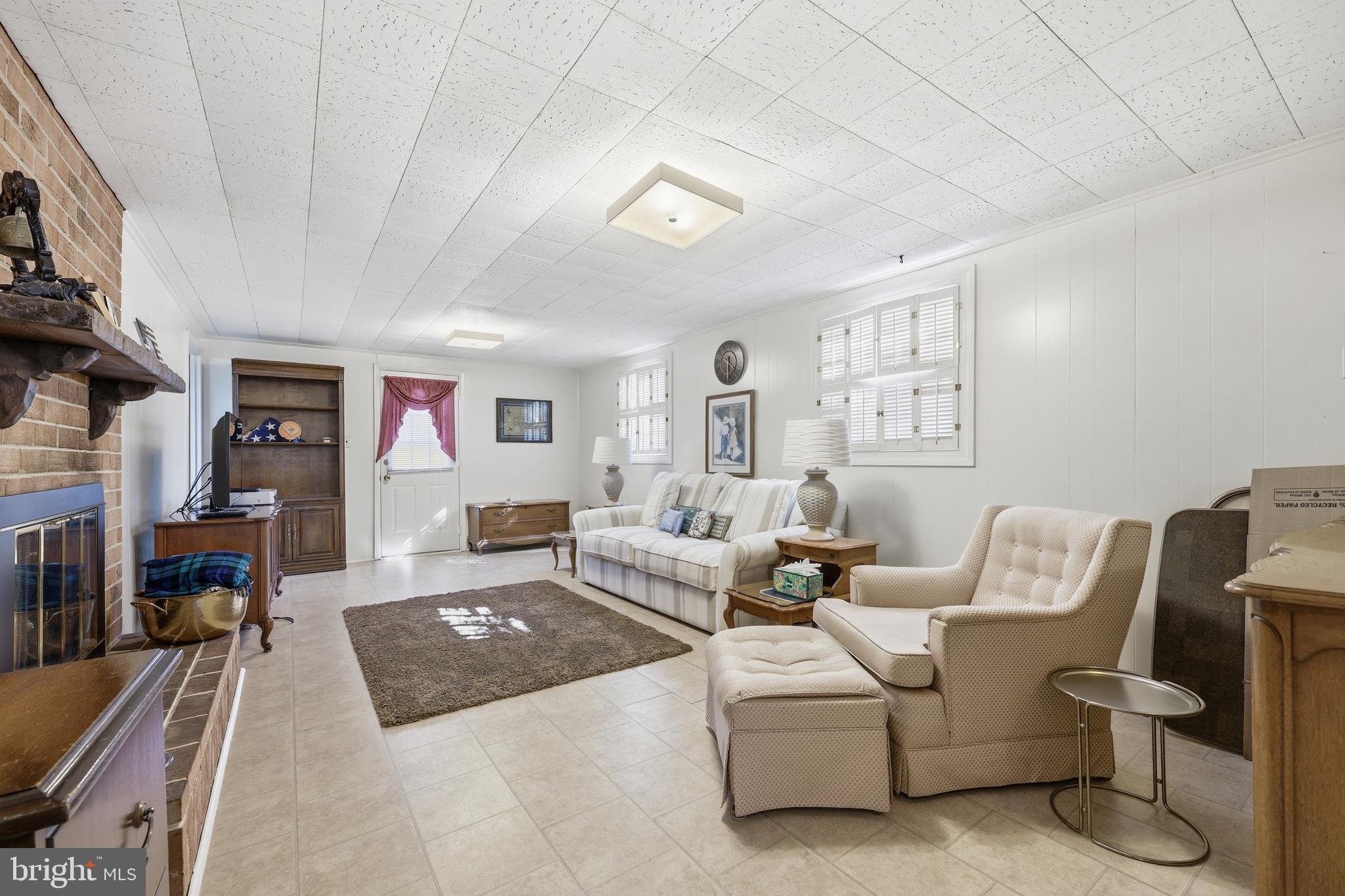 12709 Castleleigh Court Silver Spring, MD 20904 - Photo 30 of 38 a living room with furniture and a flat screen tv