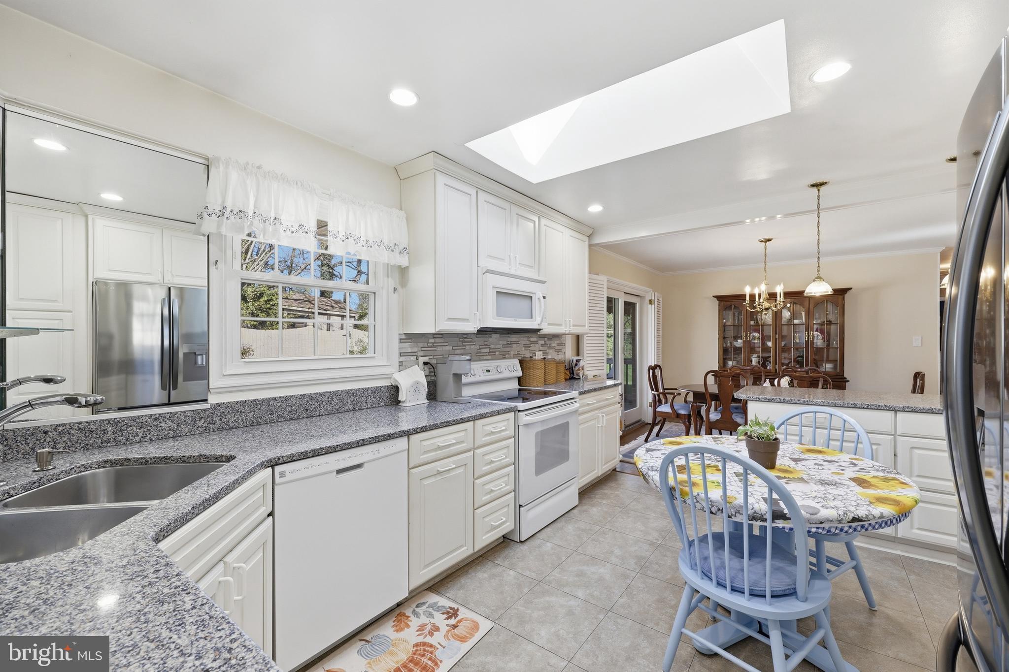 12709 Castleleigh Court Silver Spring, MD 20904 - Photo 9 of 38 a kitchen with stainless steel appliances kitchen island granite countertop a sink and cabinets