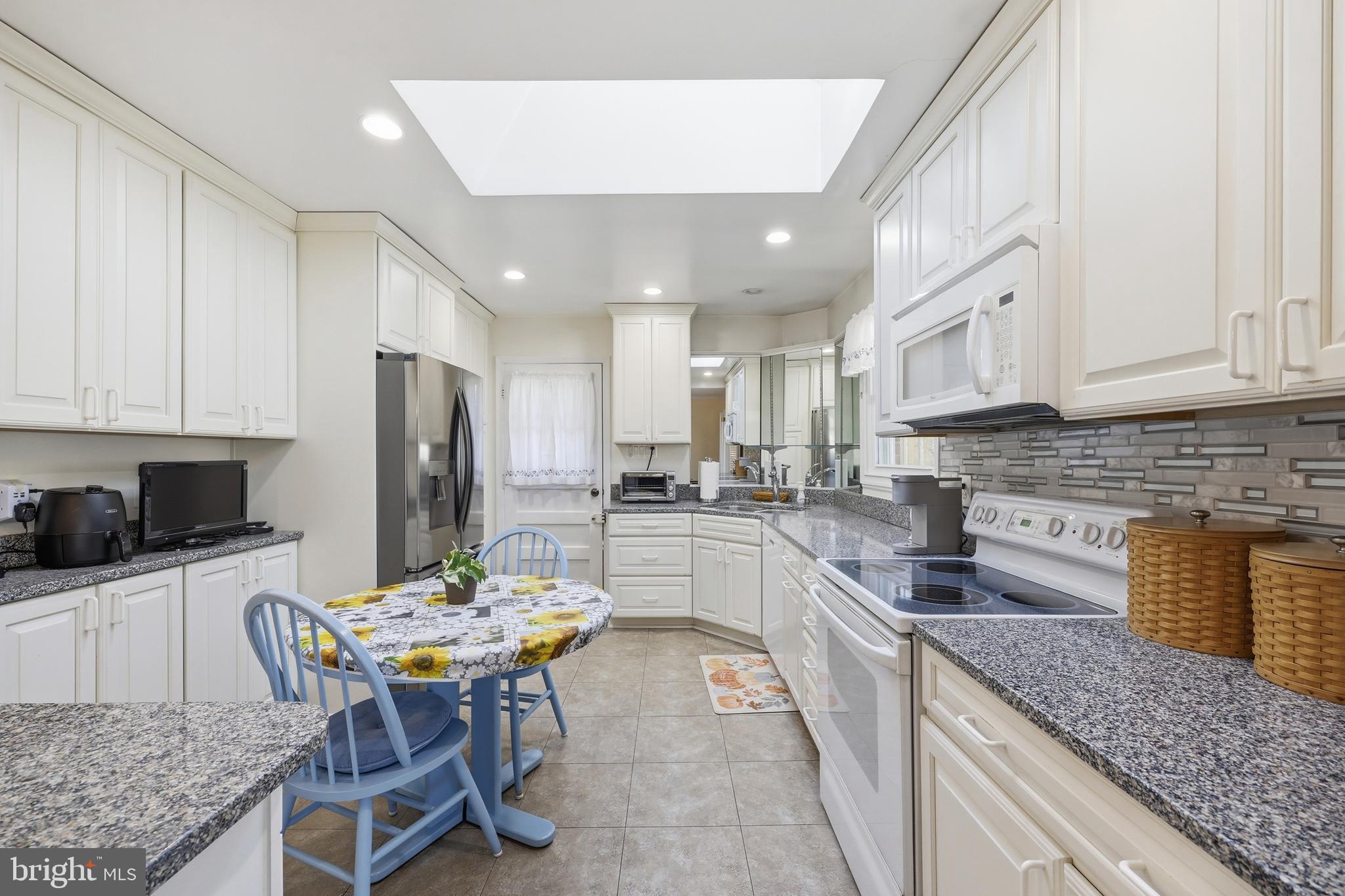 12709 Castleleigh Court Silver Spring, MD 20904 - Photo 10 of 38 a kitchen with stainless steel appliances granite countertop a kitchen island hardwood floor and a sink
