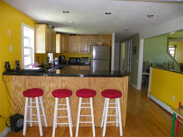 77 Mason Road Townsend, MA 01474 - Photo 4 of 11 a kitchen with a dining table chairs and a refrigerator
