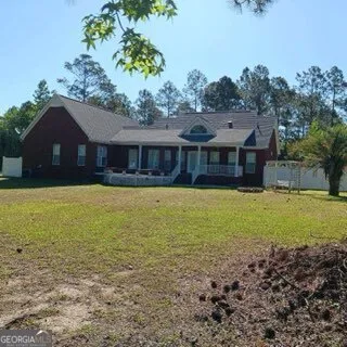 a view of a hallway with wooden floor and a living room