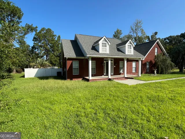 a kitchen with stainless steel appliances granite countertop a refrigerator a stove a sink and a microwave