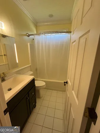 a spacious bathroom with a double vanity sink a mirror and a bathtub