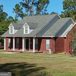 a view of a big house with a big yard
