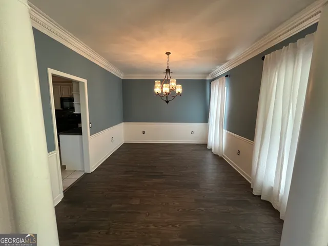 a kitchen with a refrigerator and a stove top oven
