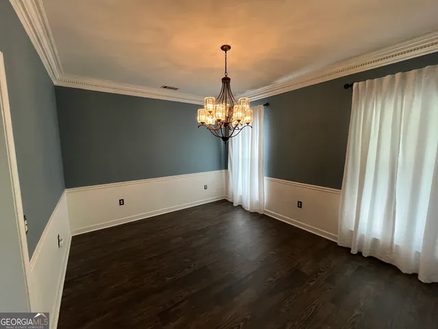 an empty room with wooden floor and a window