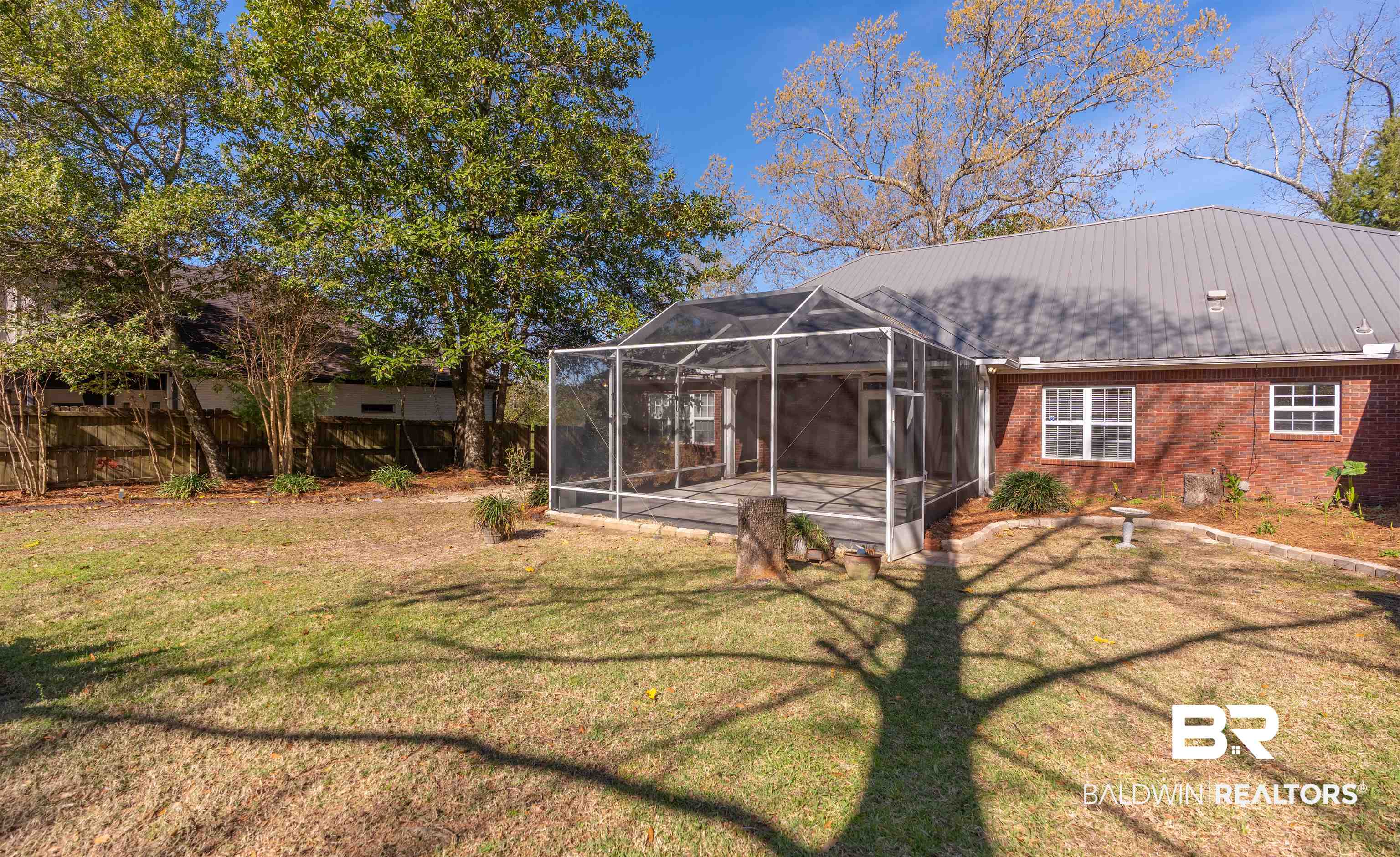 4 Judd Trail Daphne, AL 36527 - Photo 4 of 45 Back of property featuring brick siding, a patio area, a lawn, and a lanai
