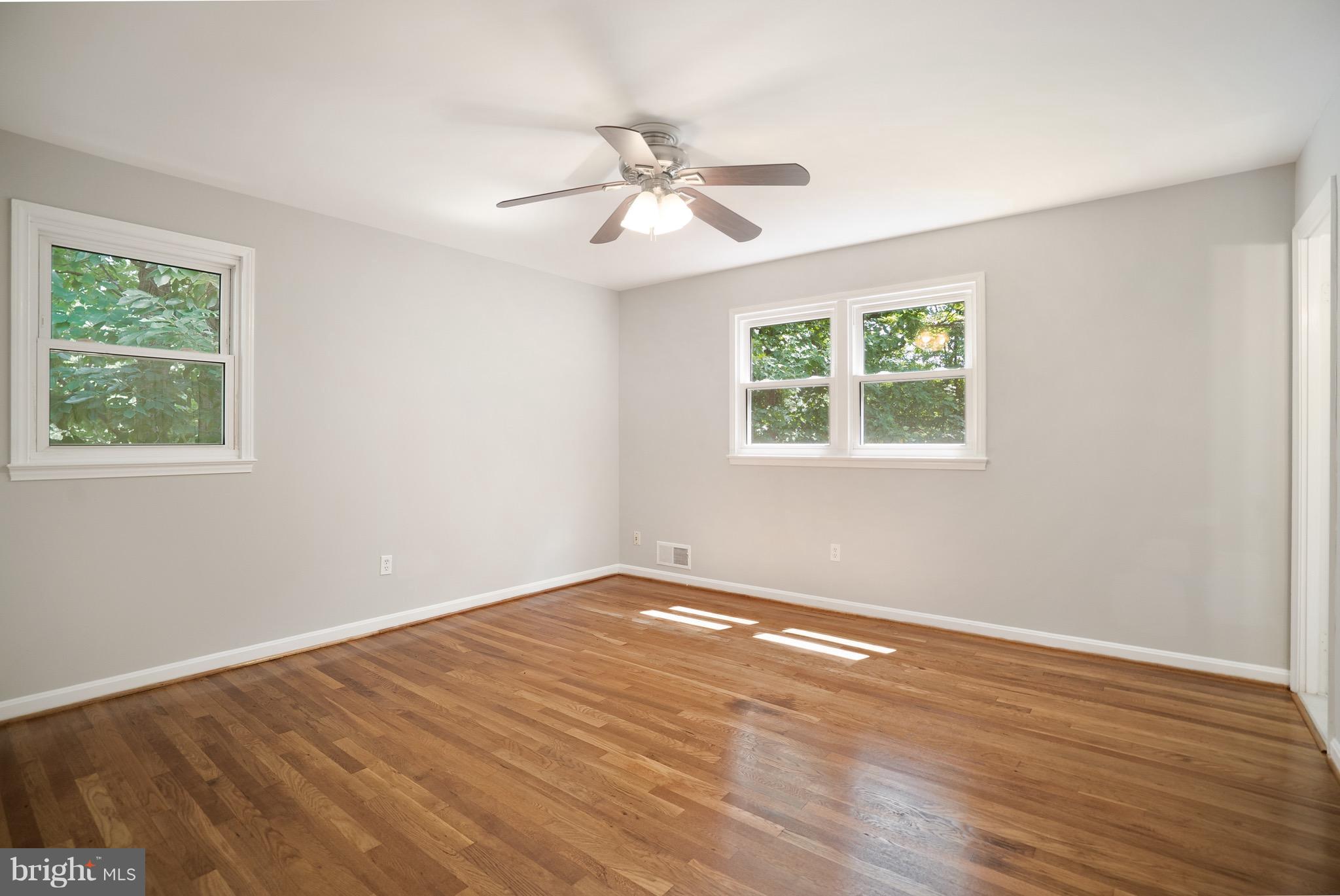 6928 Sydenstricker Road Springfield, VA 22153 - Photo 11 of 30 a view of an empty room with wooden floor and a window