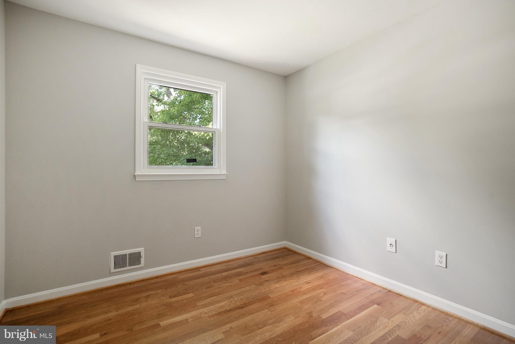 6928 Sydenstricker Road Springfield, VA 22153 - Photo 15 of 30 a view of an empty room with wooden floor and a window