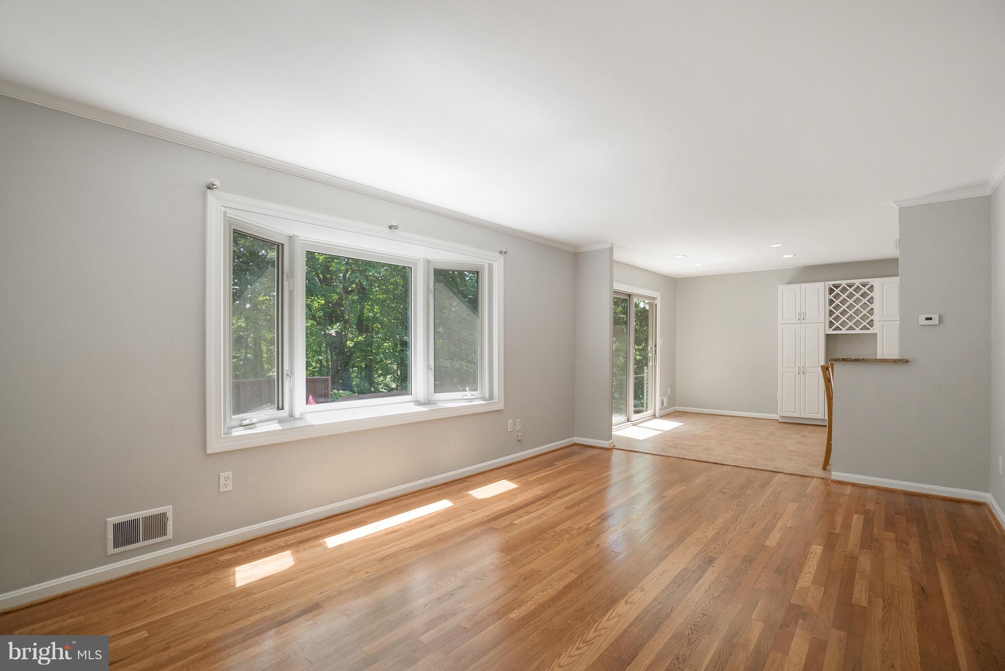 6928 Sydenstricker Road Springfield, VA 22153 - Photo 17 of 30 a view of an empty room with wooden floor and a window