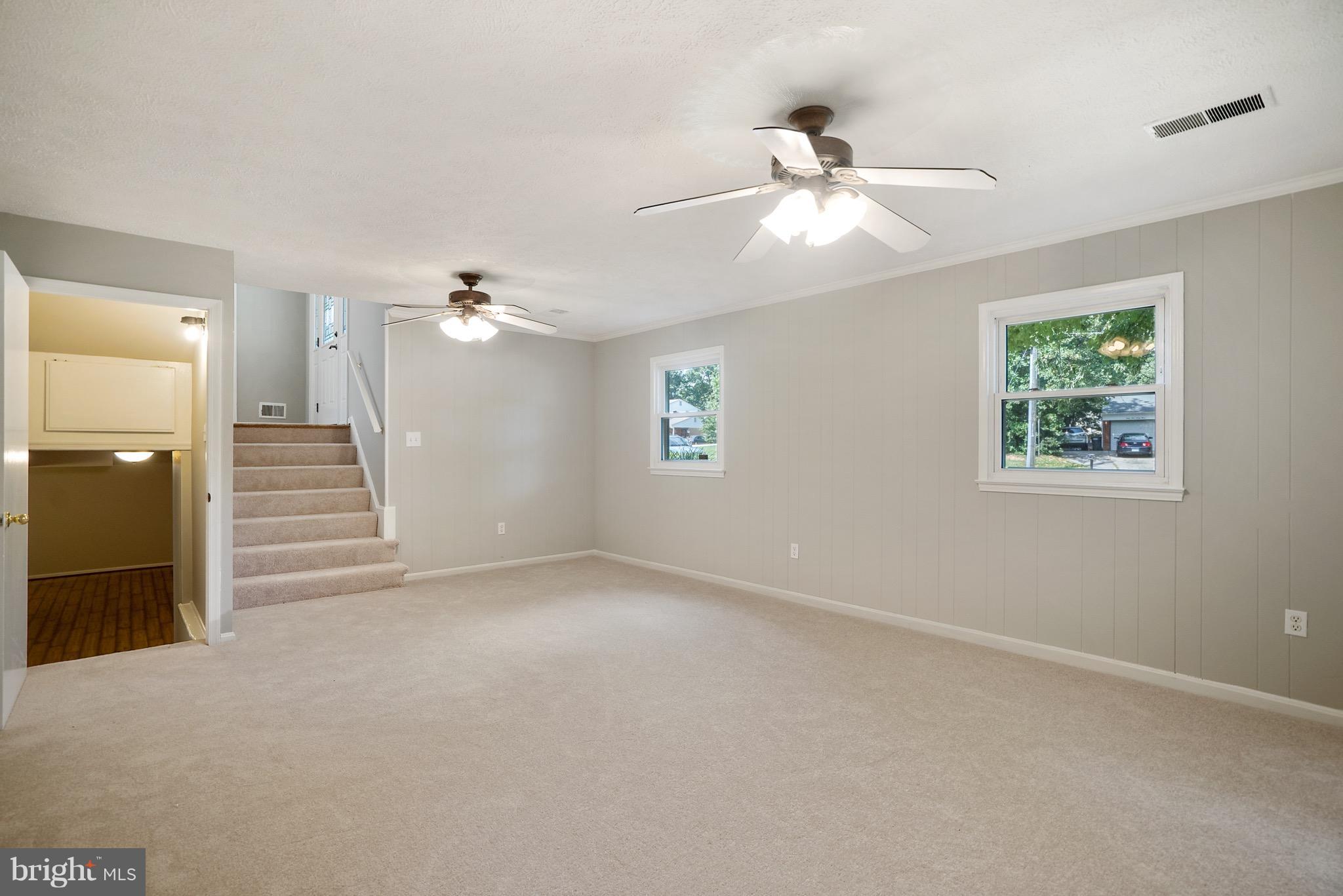 6928 Sydenstricker Road Springfield, VA 22153 - Photo 19 of 30 an empty room with windows and ceiling fan
