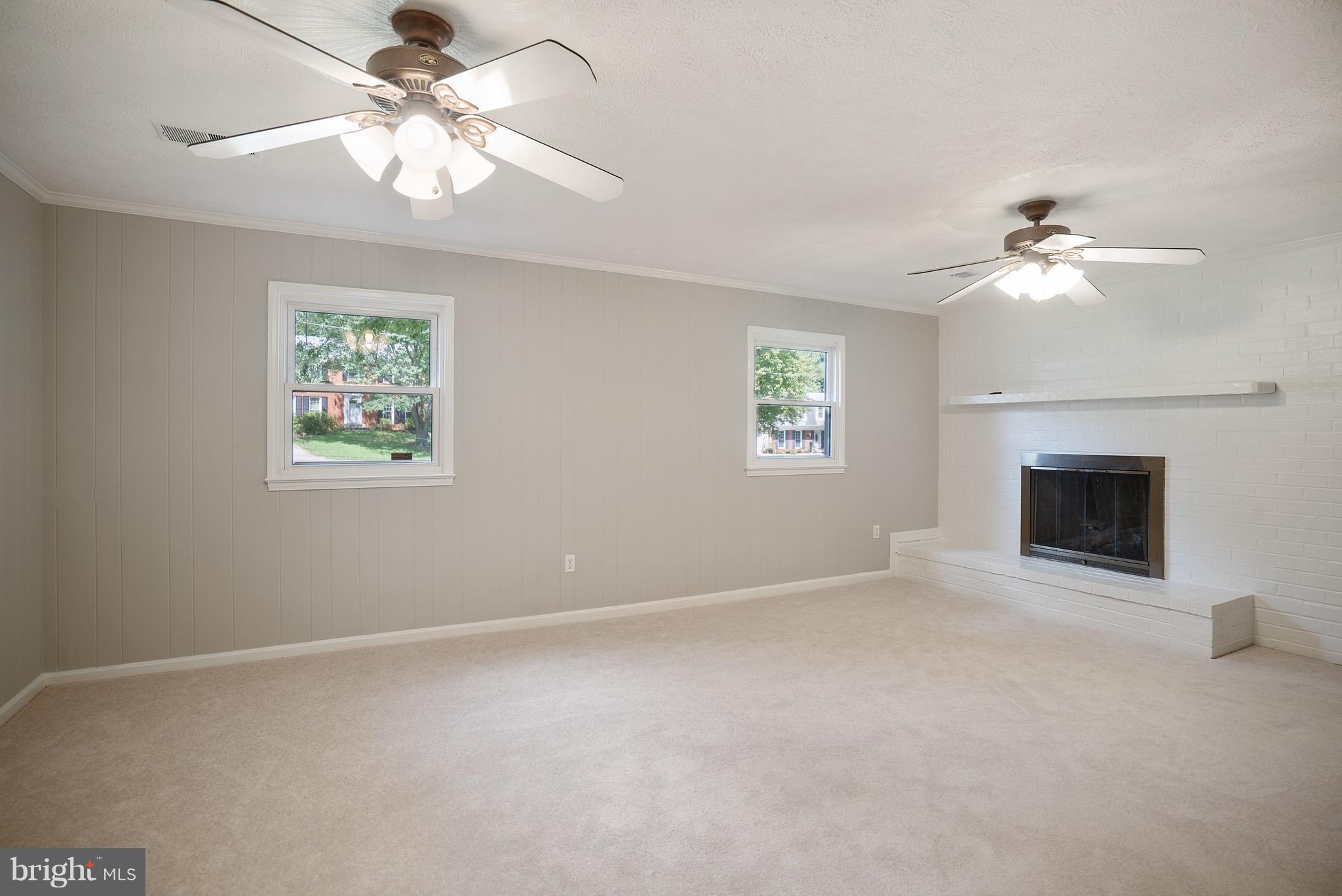 6928 Sydenstricker Road Springfield, VA 22153 - Photo 20 of 30 a view of livingroom with fan window and a fireplace