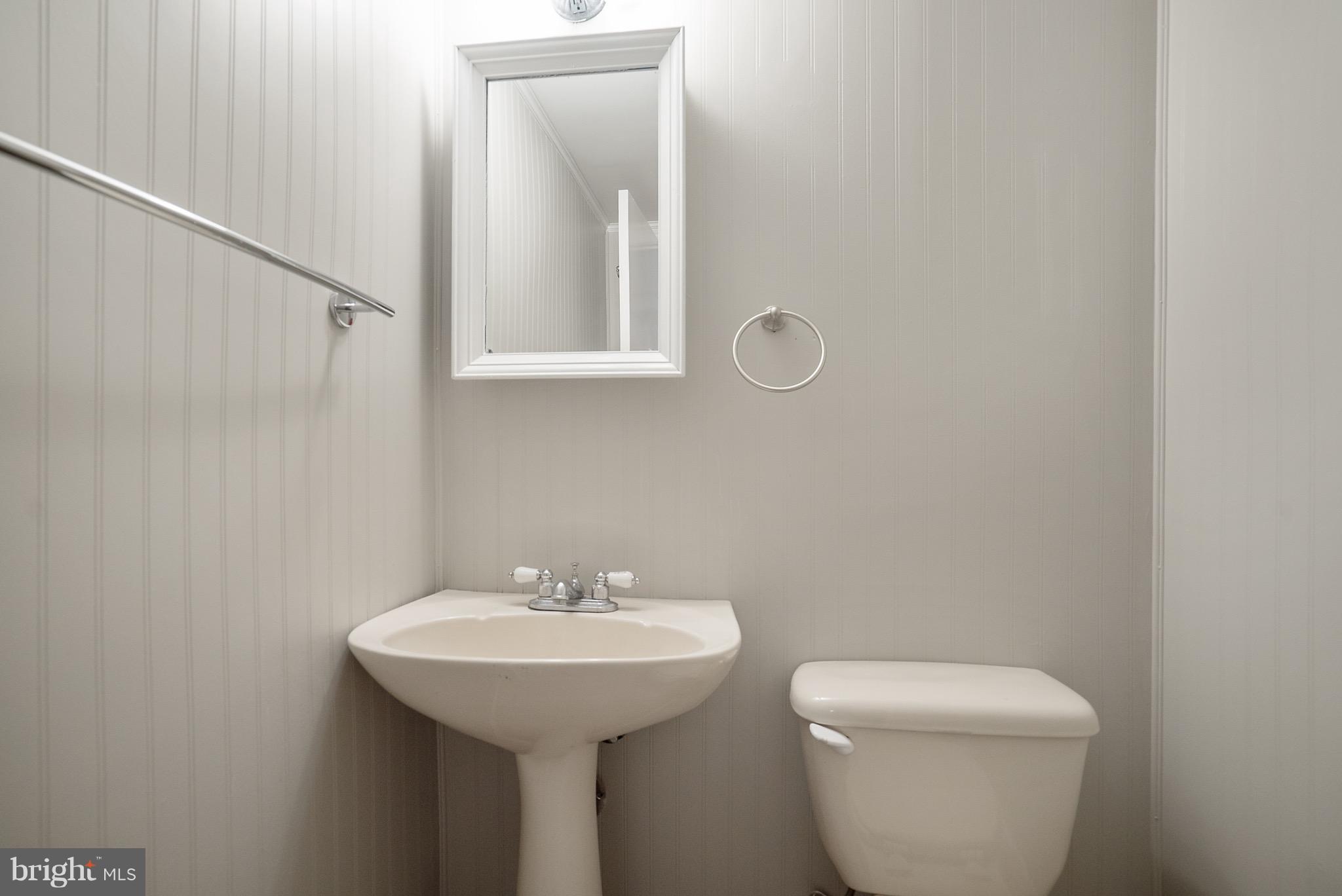 6928 Sydenstricker Road Springfield, VA 22153 - Photo 23 of 30 a bathroom with a toilet sink and mirror