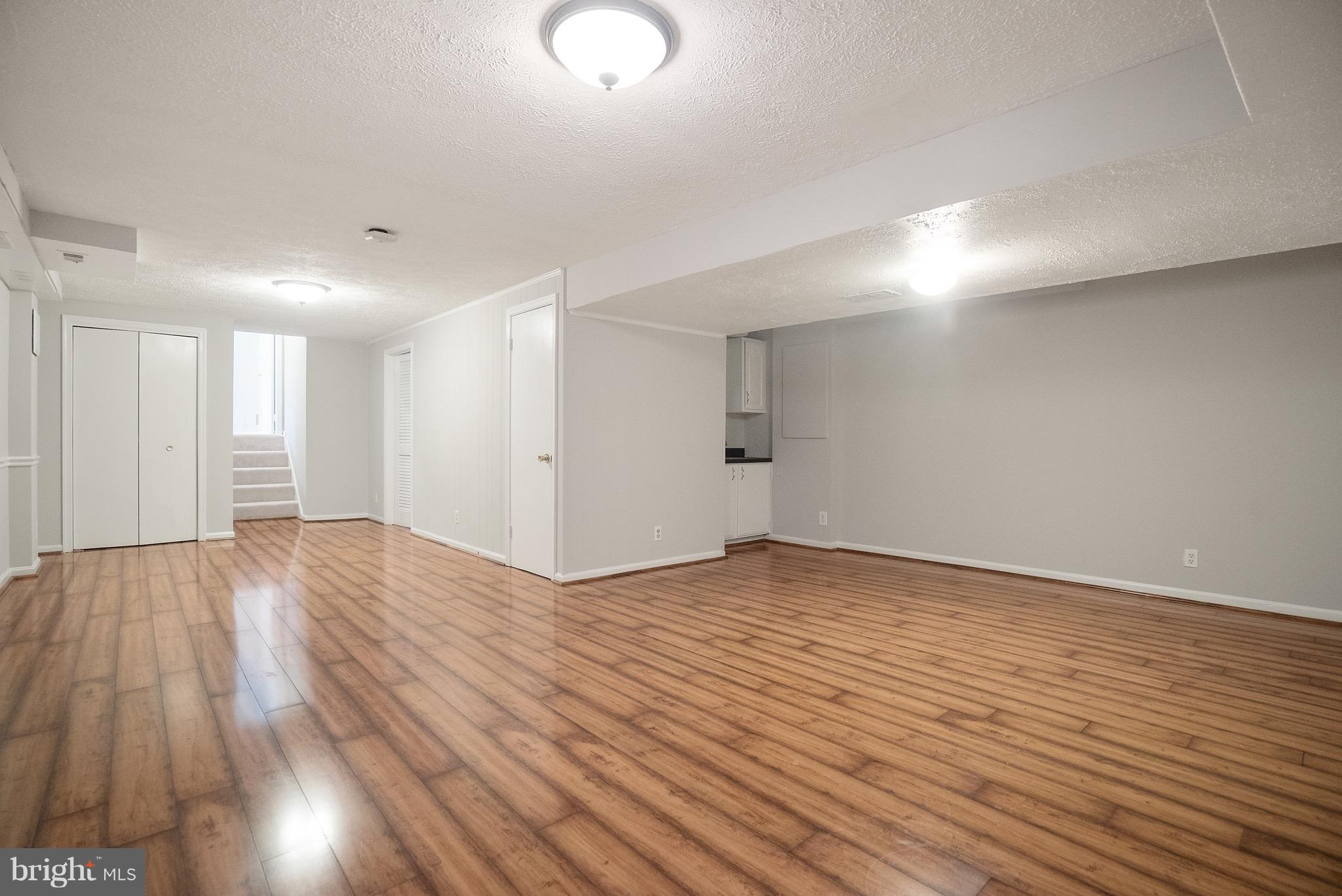 6928 Sydenstricker Road Springfield, VA 22153 - Photo 25 of 30 a view of an empty room with wooden floor