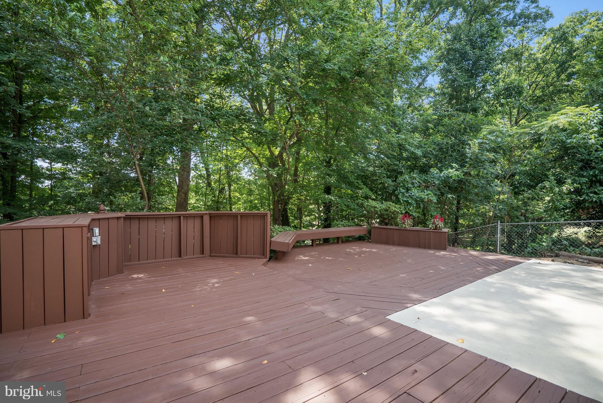 6928 Sydenstricker Road Springfield, VA 22153 - Photo 27 of 30 a view of backyard with wooden fence and large trees