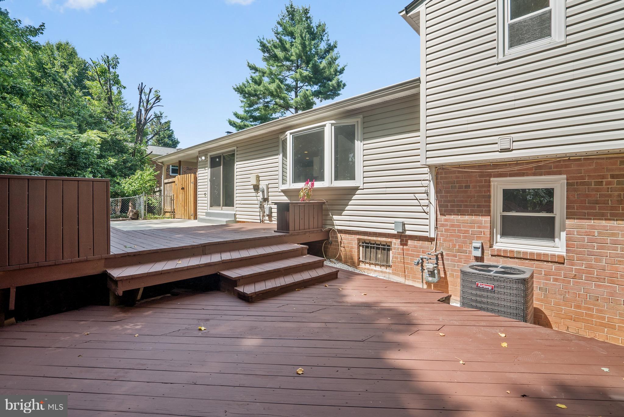 6928 Sydenstricker Road Springfield, VA 22153 - Photo 28 of 30 a view of a house with a wooden deck and a yard