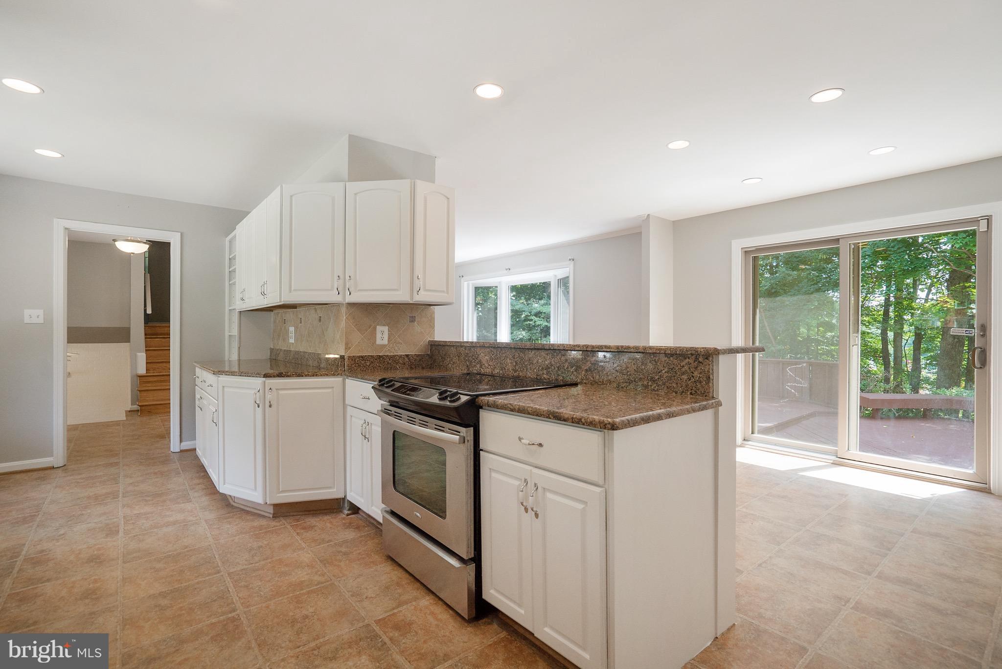 6928 Sydenstricker Road Springfield, VA 22153 - Photo 5 of 30 a kitchen that has a sink and a stove