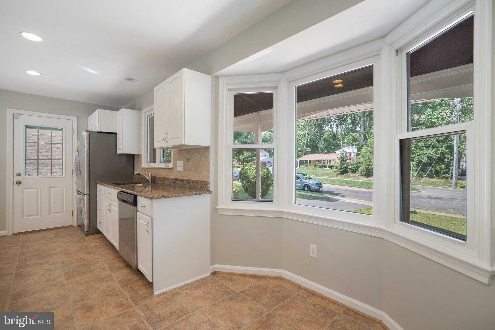 6928 Sydenstricker Road Springfield, VA 22153 - Photo 8 of 30 a kitchen with a refrigerator oven stove and a sink