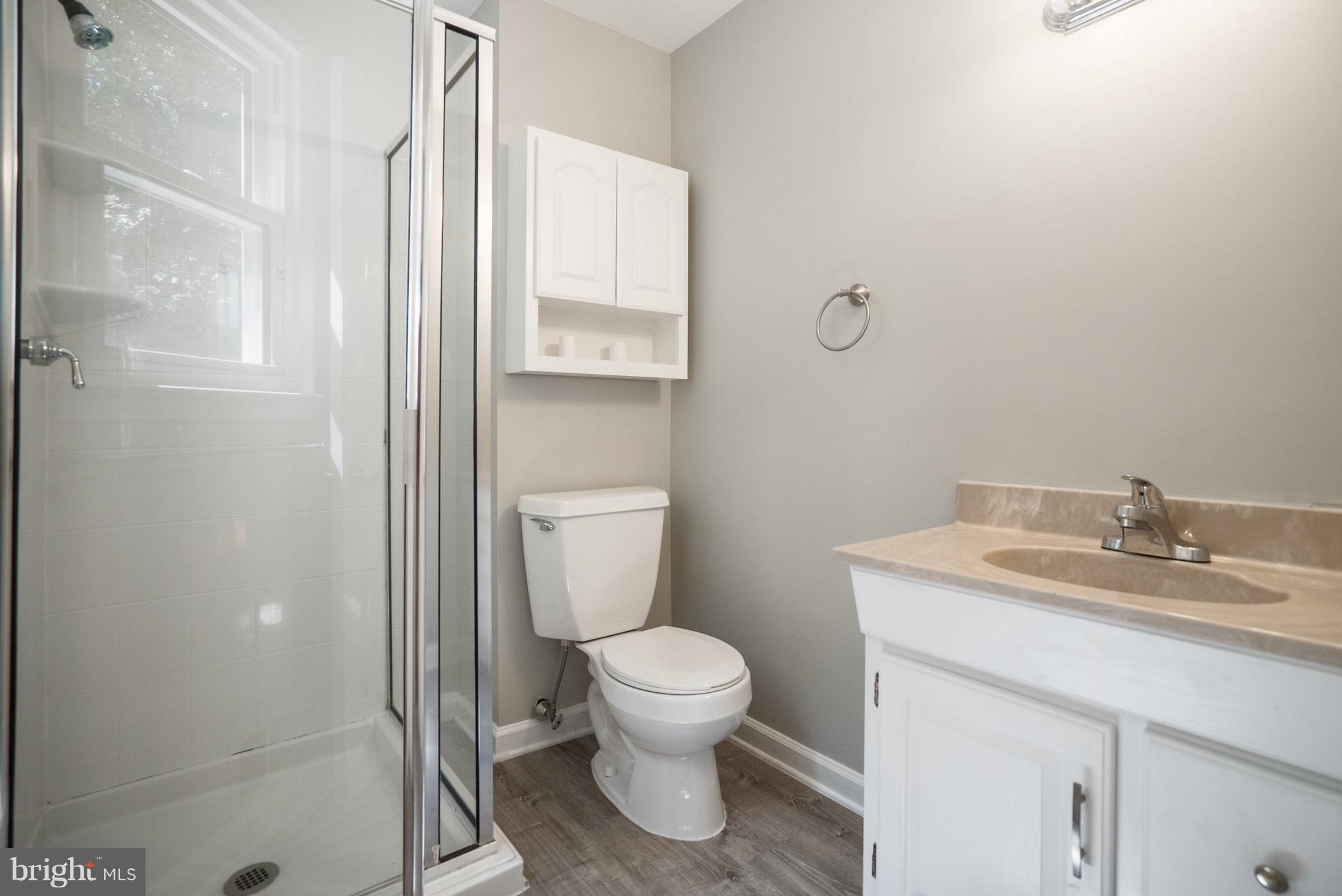 6928 Sydenstricker Road Springfield, VA 22153 - Photo 10 of 30 a bathroom with a granite countertop toilet a sink and a mirror