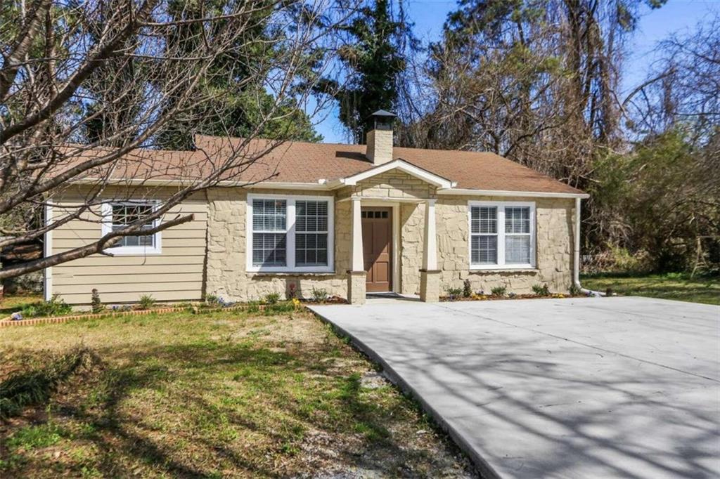 4348 Midway Road Douglasville, GA 30134 - Photo 1 of 1 a front view of a house with a garden