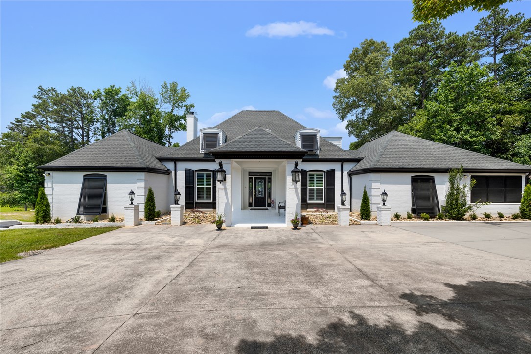 408 Northampton Road Seneca, SC 29672 - Photo 3 of 49 The property welcomes you with a concrete upper driveway leading to the elegant front entry, with expansive parking for guests and entertaining.