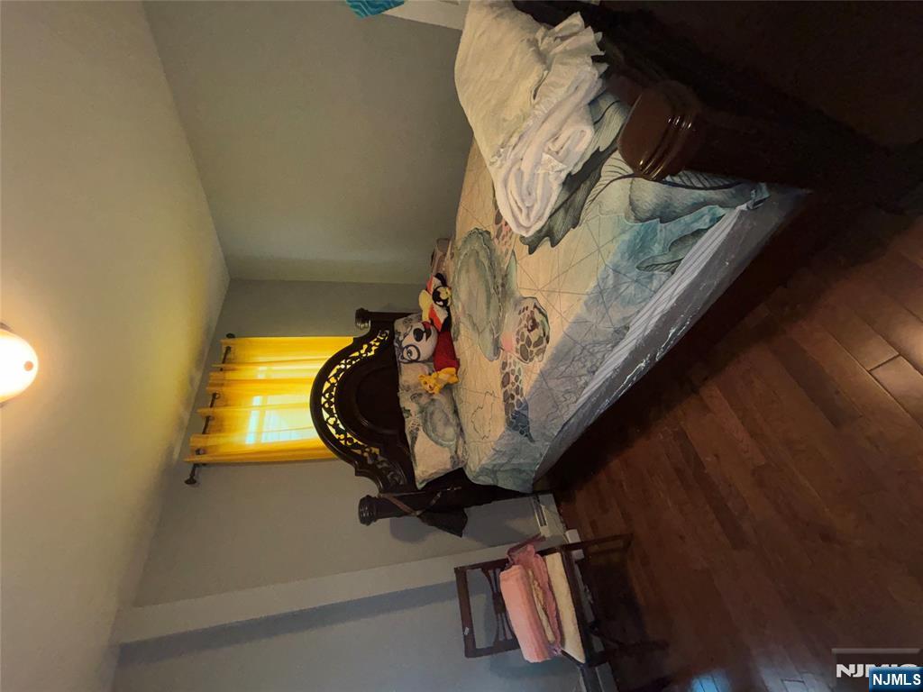 23 Oak Street Paterson, NJ 07501 - Photo 11 of 19 a bedroom with a bed and a window