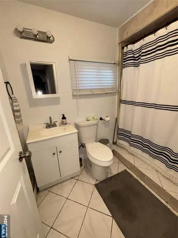 a view of a patio with table and chairs with wooden floor and fence